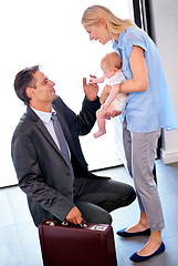Image showing Home, happiness and businessman with smile for family with love, mother and baby on hands. Accountant, male person and professional with suit in morning, father and parents together with partner