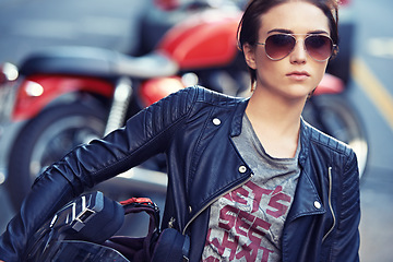 Image showing Motorcycle, sunglasses and woman biker in city with leather jacket for travel, transport or road trip. Fashion, rebel and female person with grunge, gothic or edgy punk style for bike in town.