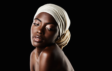 Image showing Beauty, dark background and black woman with head scarf, natural makeup or creative aesthetic in mockup space. Art, skincare and African girl in studio with wrap, facial cosmetics and confidence.