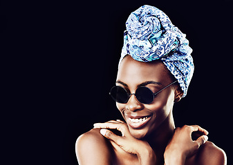 Image showing Face, smile and culture with African woman in studio isolated on black background for heritage. Aesthetic, space and sunglasses with happy young person in trendy headwear for traditional style