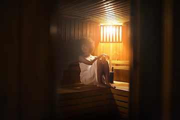 Image showing Black woman, sauna and detox at spa for self care, healing with wellness and zen at luxury resort. Relax, calm and peace on pamper day with heat or warm body treatment, skincare and stress relief