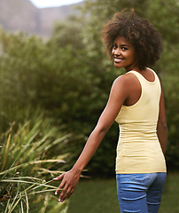 Image showing Happy, walking and portrait of black woman in nature for wellness, fresh air and relaxing outdoors. Smile, joy and face of person in park, garden and countryside for holiday, vacation and weekend