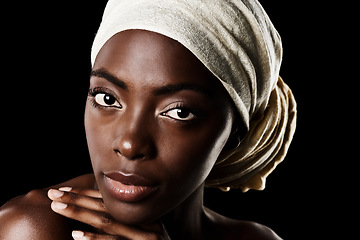 Image showing Cosmetics, portrait and black woman with head wrap, natural makeup or creative aesthetic in studio. Art, skincare and serious African girl on dark background with scarf, facial beauty and confidence.