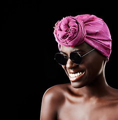 Image showing Face, fashion and happy with African woman in studio isolated on black background for heritage. Aesthetic, smile and sunglasses with confident young person in trendy headwear for traditional style