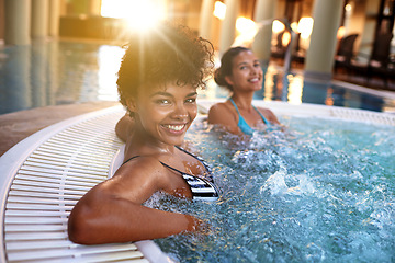 Image showing Excited woman, portrait and relax with water in jacuzzi at hotel, resort or hot tub spa together. Happy female person or friends with smile for relaxation, hospitality or heated bath by indoor pool