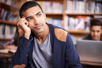 Image showing Young man, student and thinking of education in library and knowledge for exam in university. Scholarship, idea and learner with plan for assignment and college project by laptop for problem solving