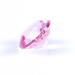 Image showing Pink diamond, jewel and stone by white background for natural resource, sparkle and luxury. Rocks, mineral and crystal in closeup for gem with shine, glow and brilliant cut with reflection in studio