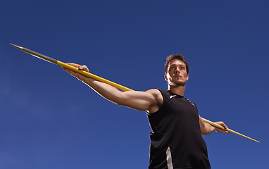 Image showing Man, athlete and javelin or blue sky at sport competition on grass or workout fitness or outdoor, strength or training. Male person, challenge and target strong or exercise performance, aim or skill