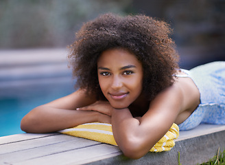 Image showing Portrait, deck and black woman relax at poolside for travel, break or chilling in a backyard on vacation. Face, smile and African female person at a wellness resort for resting on Thailand holiday