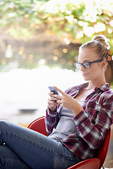 Image showing Woman, reading and online with phone outdoor for communication, social media and mobile chat with smile. Person, face and happy with smartphone for text message, internet scroll and email with bokeh