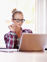 Image showing Reading, designer and woman with remote work, laptop or glasses in home office for creative ideas. Website, documents review or freelancer in a startup, business or house with online report or news