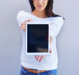 Image showing Tablet, show and hands of woman in studio background, smile and happiness for mobile and media. Presentation, female person and girl with digital device, mockup and screen of technology and internet