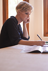 Image showing Thinking, writing and woman in home office with paperwork, research and creative professional with business budget. Freelance, remote work and girl at desk with documents for finance, notes and pen.
