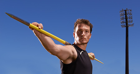 Image showing Portrait, javelin and man with fitness, sports and blue sky with workout and wellness with practice. Face, person and athlete with tournament and competition with exercise and competitor with spear
