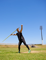 Image showing Man, athlete and javelin throw or sport competition on grass for workout fitness or outdoor, strength or training. Male person, challenge and target strong or exercise performance, aim or wellness