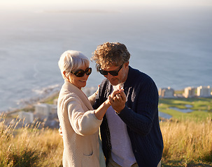 Image showing Happy, holiday and couple outdoor in dance on hill or mountain in Cape Town and holding hands with love. Mature, people and embrace with kindness on vacation adventure in nature and relax together