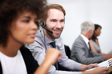 Image showing Call center, smile and man in office with headset working on online telemarketing consultation. Happy, customer support and professional male consultant with crm service communication in workplace.