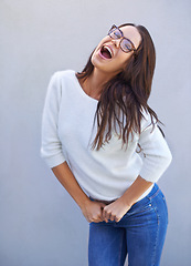 Image showing Laugh, smile and happy woman for fashion, style and clothing range isolated on gray background. Female person, lady and expression for casual outfit, eyewear and apparel with confidence in studio