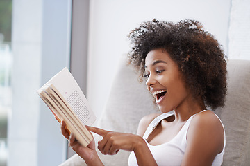 Image showing Happy, black woman and reading with book on sofa for novel, story or literature in living room at home. African female person with surprise for information, news or interesting knowledge at the house