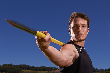Image showing Portrait, javelin and man with fitness, training and blue sky with sports and wellness with practice. Face, person and athlete with tournament and competition with exercise and workout with blue sky
