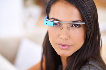 Image showing Woman, portrait and serious with smart glasses in home for virtual reality, high tech information and digital eyewear. VR, person and futuristic vision for communication, research and mockup in house