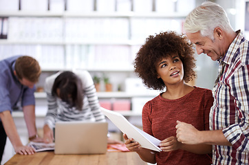 Image showing Office, documents and woman talking to senior in creative workplace for project or deal for company. Colleagues, employee and staff collaboration with laptop, technology and internet in boardroom