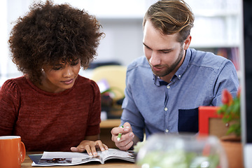 Image showing Creative, business people and reading with magazine for journalism, information or content at the office. Man and woman working together with novel, story or news for design or startup at workplace