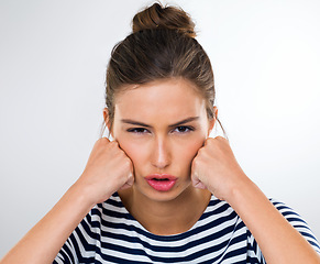 Image showing Portrait, frustrated and angry with woman, stress and anxiety on a white studio background. Face, person and model with reaction and extreme emotion with expression and upset with emoji and crisis