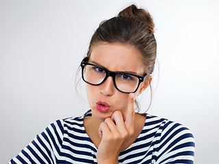 Image showing Woman, glasses and expression for eyewear, watching and vision for thinking, idea and angry on white backdrop. Young person and finger on specs for crazy, annoyed and emotions with gesture and moody