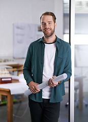 Image showing Portrait, smile and blueprint with architect man in office with documents for building, design or planning. Architecture, construction and industry with happy young developer in creative workplace