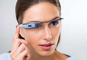 Image showing Press, woman and futuristic glasses for augmented reality, metaverse or serious in studio isolated on white background. Face, cyber eyewear and smart tech, virtual or digital spectacles for vision