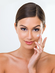 Image showing Woman, portrait and cream for skin with beauty in studio, cosmetics product with hand and makeup on white background. Sunscreen, lotion or moisturizer for facial, antiaging and skincare treatment