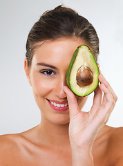 Image showing Woman, portrait and avocado for health in studio for wellness detox, healthy skin or hydration with smile. Model, person or fruit for organic cosmetics, natural beauty or skincare on white background