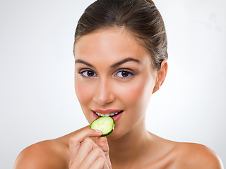 Image showing Woman, portrait or cucumber for eating in studio with wellness detox, healthy vegetable or nutrition diet. Model, person or fruit for organic cosmetics, natural beauty or skincare on white background