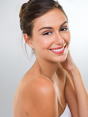 Image showing Woman, face and skincare with dermatology for beauty, smile with shine and antiaging on white background. Happy in portrait, cosmetic care and healthy skin glow with headshot and makeup in studio