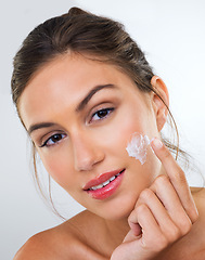 Image showing Woman, cream on face and skincare for beauty, dermatology with cosmetics product or moisturizer in studio. Portrait, skin wellness with sunscreen or lotion for glow and antiaging on white background