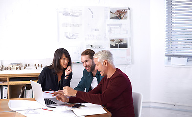 Image showing Architects, laptop and discussion with office, diversity and meeting and creative partnership. Businessman, plans and engineering with blueprint, brainstorming and problem solving for startup agency