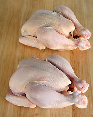 Image showing Two raw chickens on a chopping board