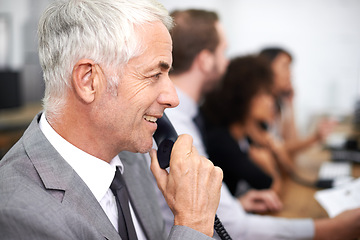 Image showing Call center, man and landline in office for telemarketing with customer service, help desk and conversation. Senior, employee and happy consultant with telephone for support, telesales and advice