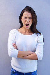 Image showing Studio, portrait and woman feeling offended, shocked and angry with emotion and confused by news. Blue background, female person and girl with question of why with arms crossed and surprised