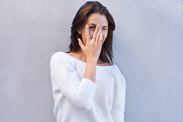 Image showing Fashion, studio and woman hiding face for aesthetic of sweater, shy and casual with clothes. Blue background, female person and girl with hand to cover mouth and jersey for winter in America