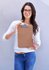 Image showing Portrait, smile and woman with clipboard to show, empty and blank to support information or documents. Studio background, female person and girl with glasses for intelligence with single form holder