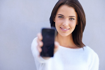 Image showing Portrait, smile and woman with phone, presentation and product placement for advertising mobile. Studio background, female person and girl with happiness for cellphone, digital and technology