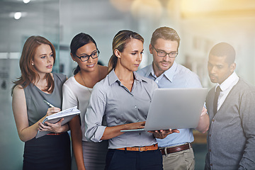 Image showing Group, mentor and team collaboration with laptop helping and training employees in office. People, reading and learning from woman coaching staff in IT with advice for software or feedback on project