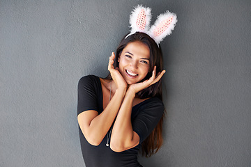 Image showing Bunny ears, happy or portrait of woman with fashion isolated on wall or grey background with style. Funny joke, confident lady or casual female person in studio with pride, smile and trendy clothes