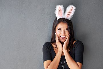 Image showing Bunny ears, space or portrait of woman on easter holiday isolated on wall or grey background with style. Happy model, confident lady or excited person in studio with smile, joy or announcement mockup