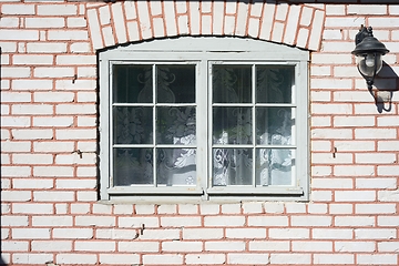 Image showing old window in a brick house and a lantern on the wall