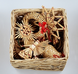 Image showing traditional Christmas straw decorations in a wicker box