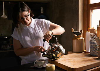 Image showing Prepare, tea and woman in kitchen with drink in morning for calm break or routine process in home. Healthy, matcha or person with kettle for breakfast beverage to start holiday or vacation and relax