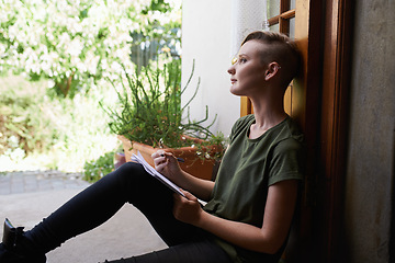 Image showing Woman, writing notes and thinking on floor in home for brainstorming, reflection and serious by garden. Dream, notepad and student with creative ideas, inspiration and planning to do list on journal